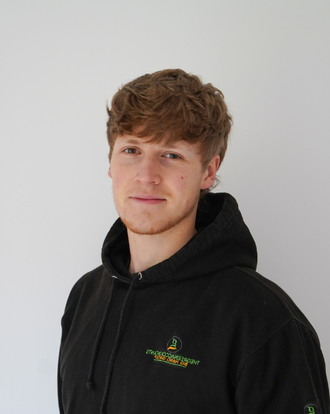 Professional head-shot of a woman smiling in front of a neutral background.