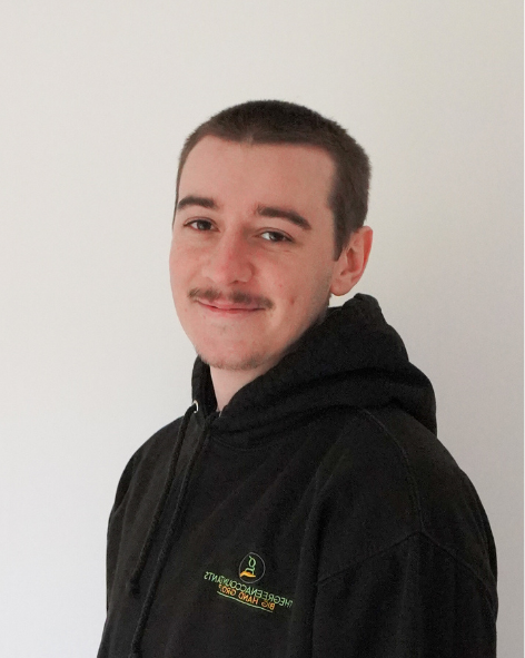 Professional head-shot of a man smiling at the camera.