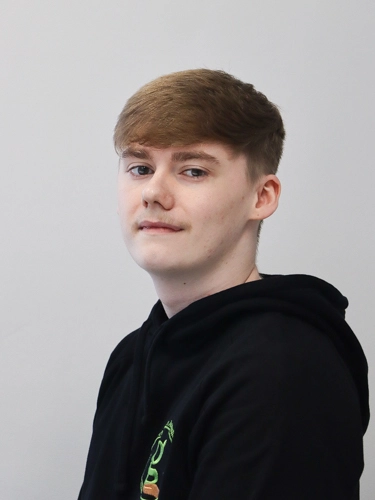 Professional head-shot of a man smiling at the camera.